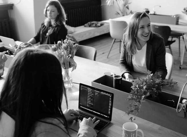 Three people are working and discussing with each other energetically.